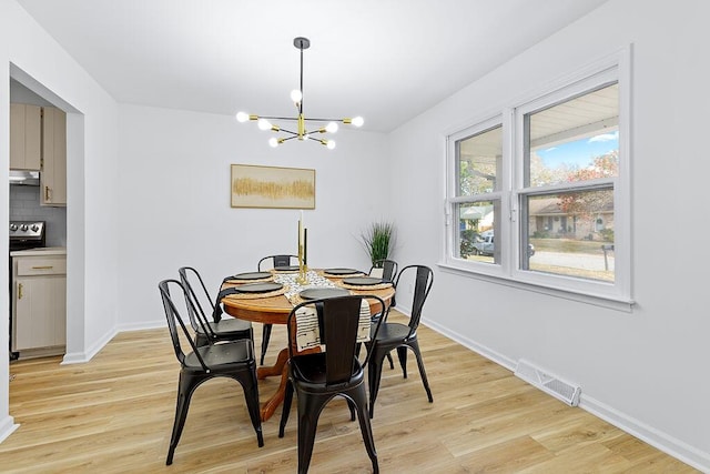 dining area featuring a chandelier and light wood-type flooring