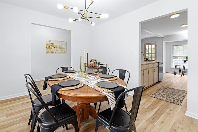 dining room featuring a chandelier, light hardwood / wood-style floors, and sink