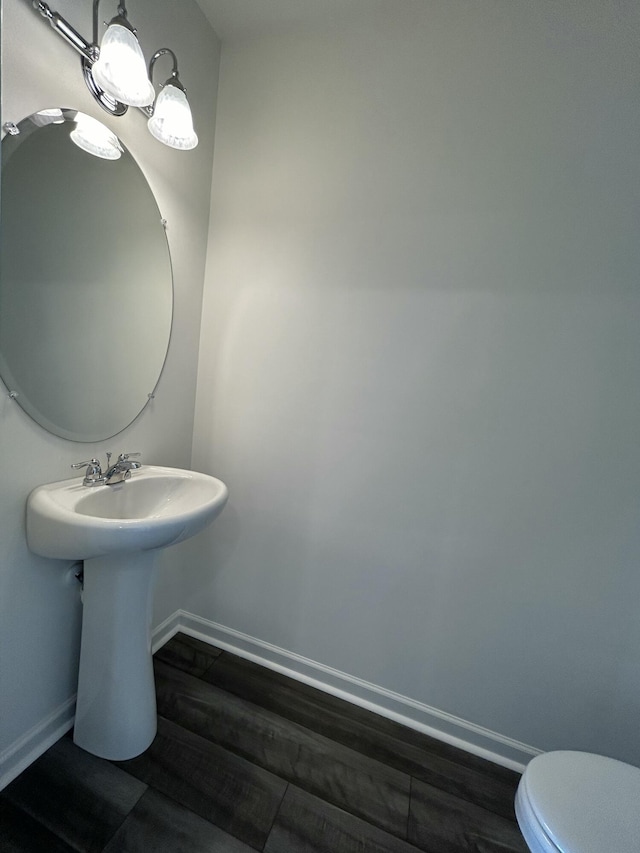 2007 Scarlett Maple St, Summerville, SC 29486 - half bath featuring wood finished floors, baseboards, toilet, and a sink