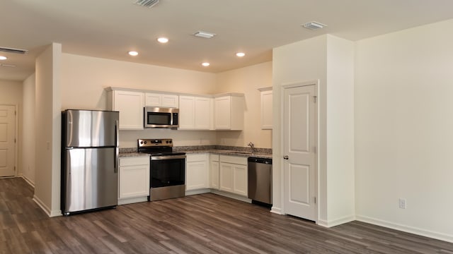 2007 Scarlett Maple St, Summerville, SC 29486 - kitchen with appliances with stainless steel finishes, dark wood-style floors, white cabinetry, recessed lighting, and stone counters