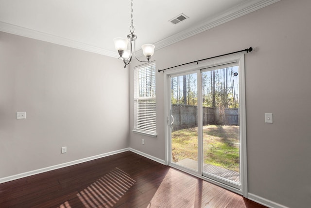 unfurnished dining area with dark hardwood / wood-style flooring, ornamental molding, and a notable chandelier