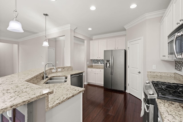 kitchen featuring appliances with stainless steel finishes, pendant lighting, white cabinets, and sink