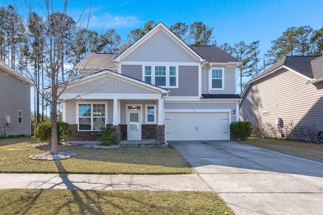 craftsman house with a garage and a front lawn