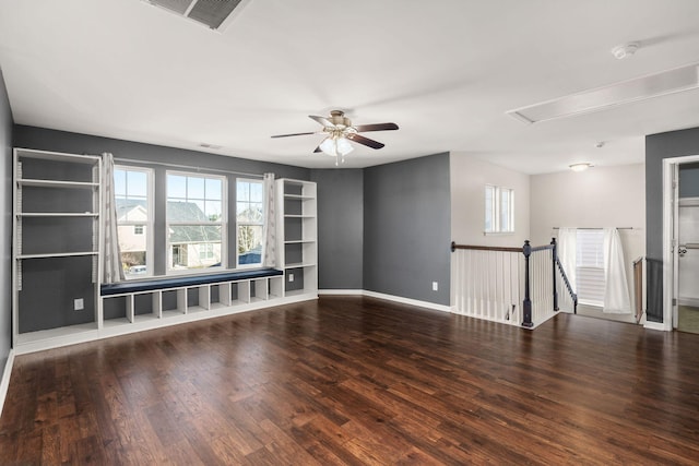 empty room featuring ceiling fan, dark hardwood / wood-style flooring, and a wealth of natural light