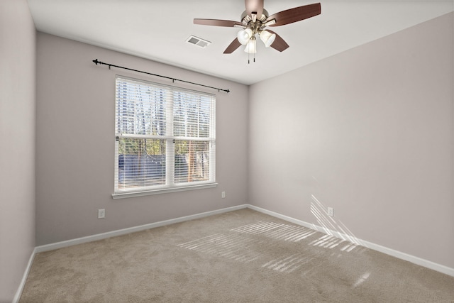 carpeted spare room with ceiling fan