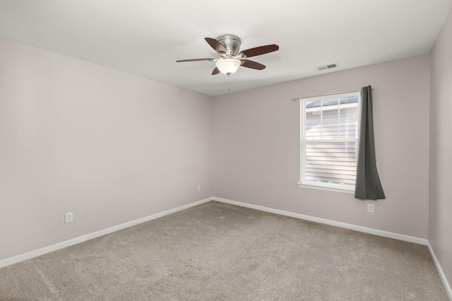 spare room featuring carpet floors and ceiling fan