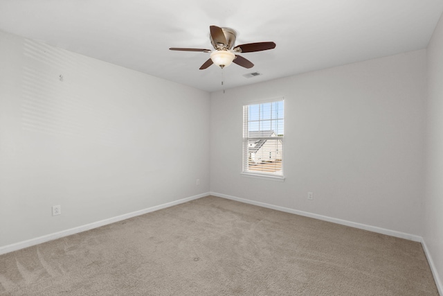 carpeted spare room with ceiling fan