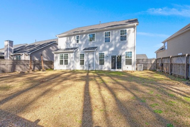 rear view of property with a yard