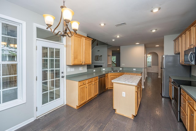 1629 Jorrington St, Mount Pleasant, SC 29466 - kitchen with appliances with stainless steel finishes, a peninsula, a chandelier, dark wood-style flooring, and arched walkways