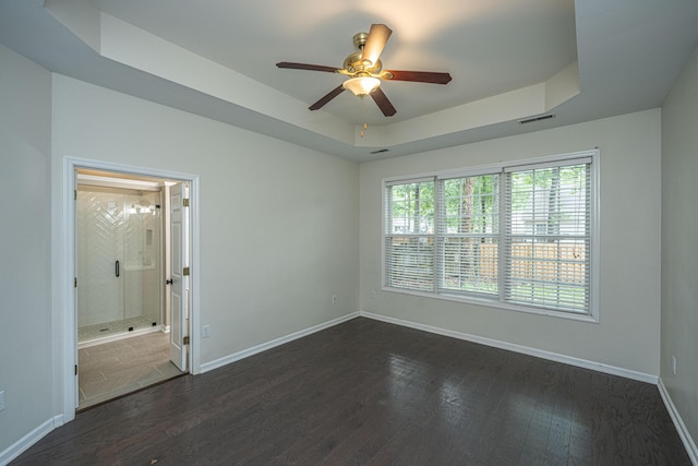1629 Jorrington St, Mount Pleasant, SC 29466 - empty room featuring a raised ceiling, a ceiling fan, and dark wood-style flooring