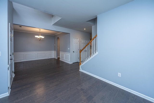 1629 Jorrington St, Mount Pleasant, SC 29466 - unfurnished room with a chandelier, arched walkways, dark wood-style floors, stairs, and ornamental molding