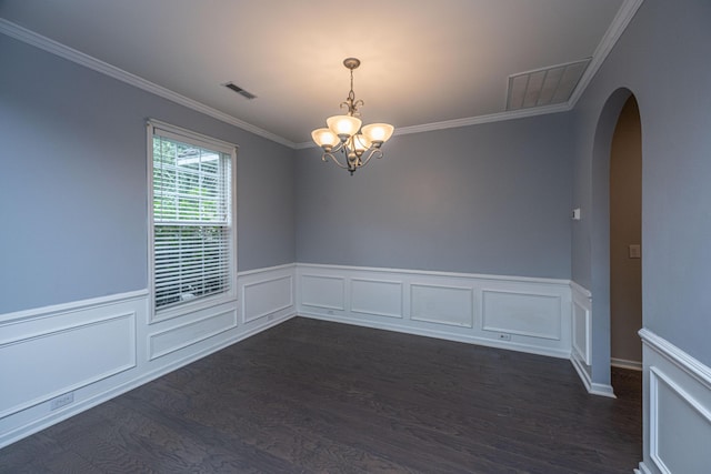 1629 Jorrington St, Mount Pleasant, SC 29466 - spare room featuring arched walkways, a chandelier, crown molding, dark wood-style flooring, and wainscoting