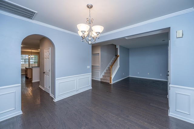1629 Jorrington St, Mount Pleasant, SC 29466 - spare room with a chandelier, arched walkways, stairs, a wainscoted wall, and crown molding