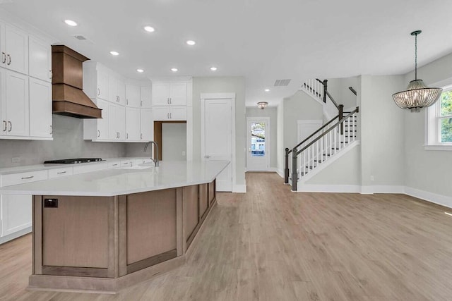 1183 Reserve Ln, Awendaw, SC 29429 - kitchen featuring custom exhaust hood, light wood-type flooring, white cabinetry, and recessed lighting