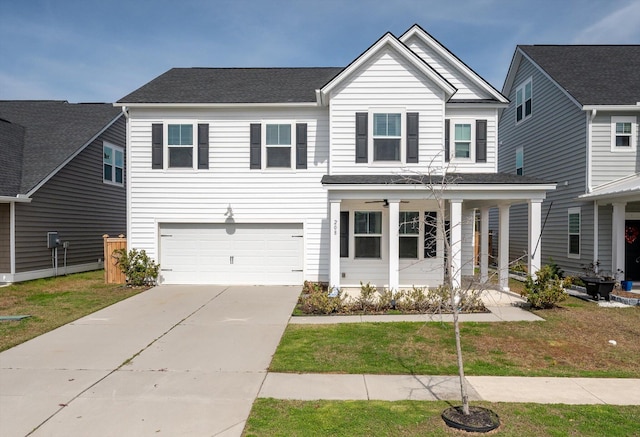 traditional-style house featuring covered porch, concrete driveway, and a front yard