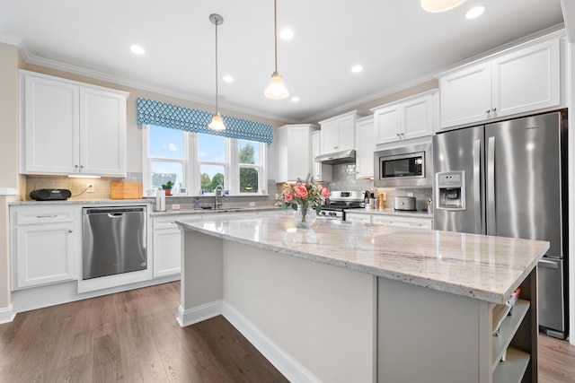 kitchen featuring a kitchen island, decorative light fixtures, sink, white cabinets, and stainless steel appliances