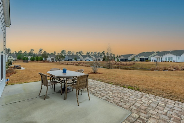 patio terrace at dusk with a lawn