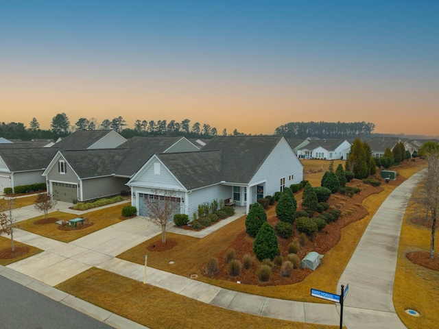 view of front facade featuring a garage and a lawn