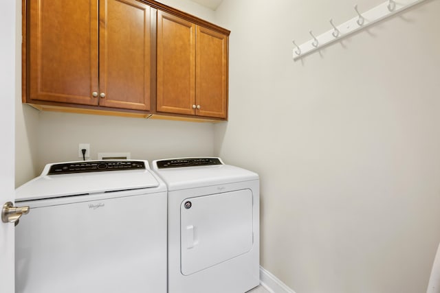 laundry room with cabinets and separate washer and dryer