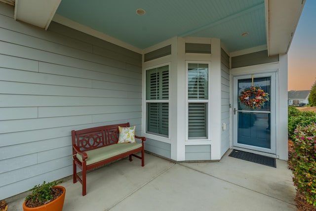 view of exterior entry at dusk