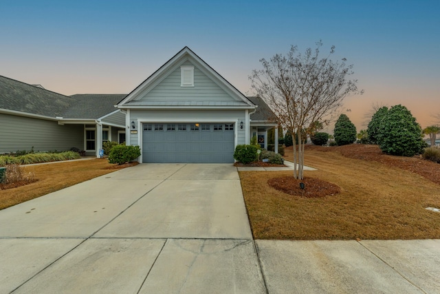 view of front of house with a yard and a garage