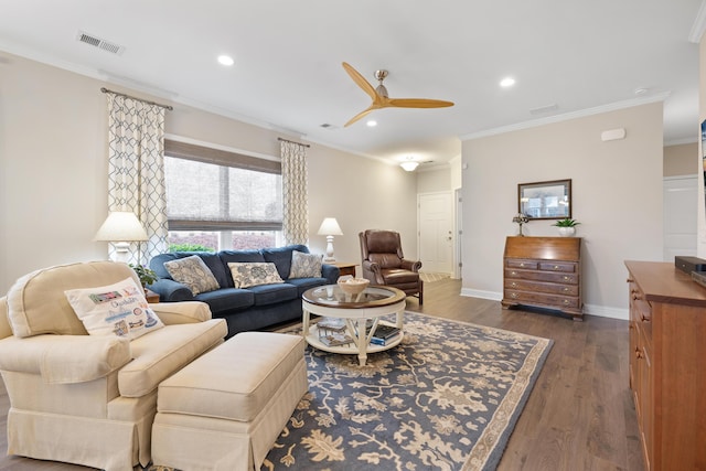 living room featuring crown molding, dark wood-type flooring, and ceiling fan