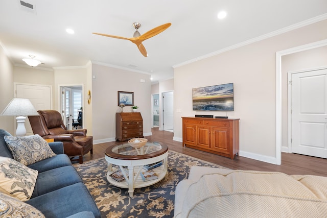 living room with dark hardwood / wood-style flooring, ornamental molding, and ceiling fan