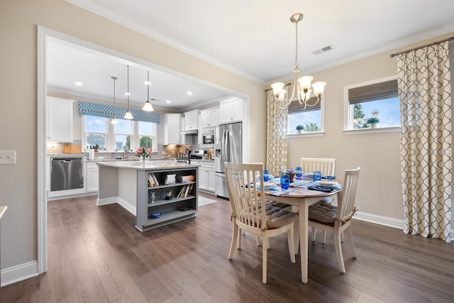 dining room with crown molding, plenty of natural light, and dark hardwood / wood-style floors