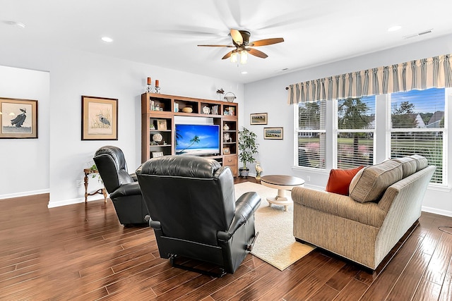 living room featuring ceiling fan, dark hardwood / wood-style floors, and a wealth of natural light