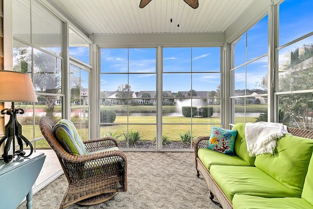 sunroom / solarium with ceiling fan, a wealth of natural light, and a water view