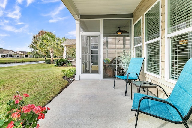 view of patio / terrace featuring ceiling fan and a water view