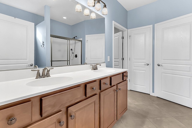 bathroom featuring walk in shower, vanity, and tile patterned flooring