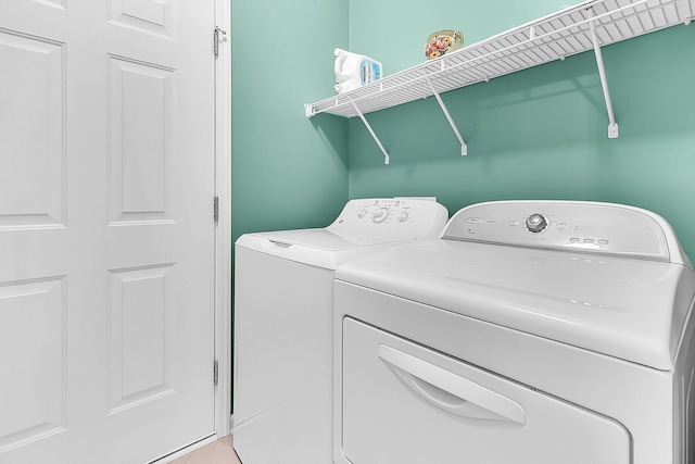 washroom with independent washer and dryer