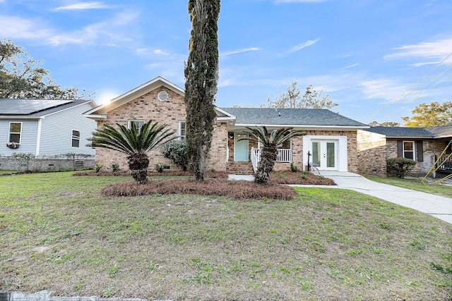 view of front of house with brick siding and a front yard