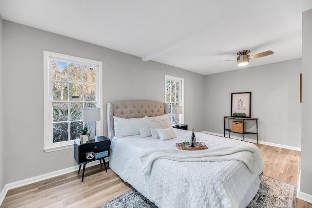 bedroom featuring baseboards, light wood-style floors, and ceiling fan