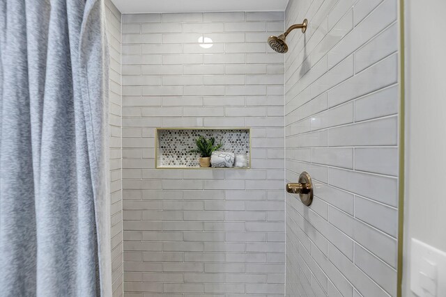 full bathroom with a tile shower