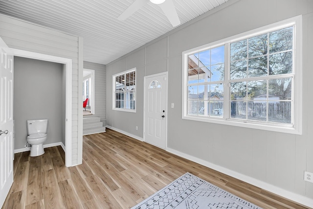 foyer with baseboards, light wood-type flooring, and ceiling fan