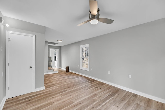 unfurnished room with ceiling fan, baseboards, and light wood-style floors