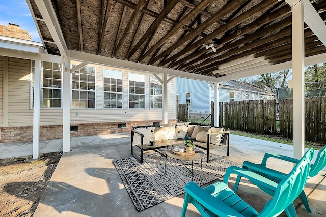 view of patio with an outdoor living space and fence