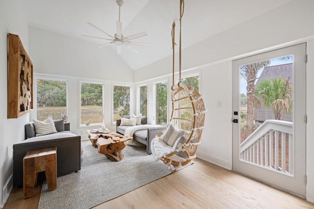 sunroom with ceiling fan, lofted ceiling, and plenty of natural light