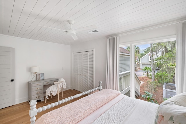 bedroom with wood ceiling, light hardwood / wood-style floors, a closet, and ceiling fan