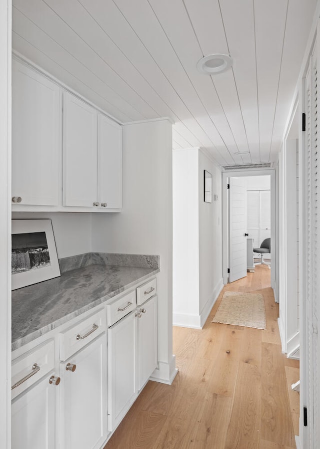 hallway with light hardwood / wood-style floors