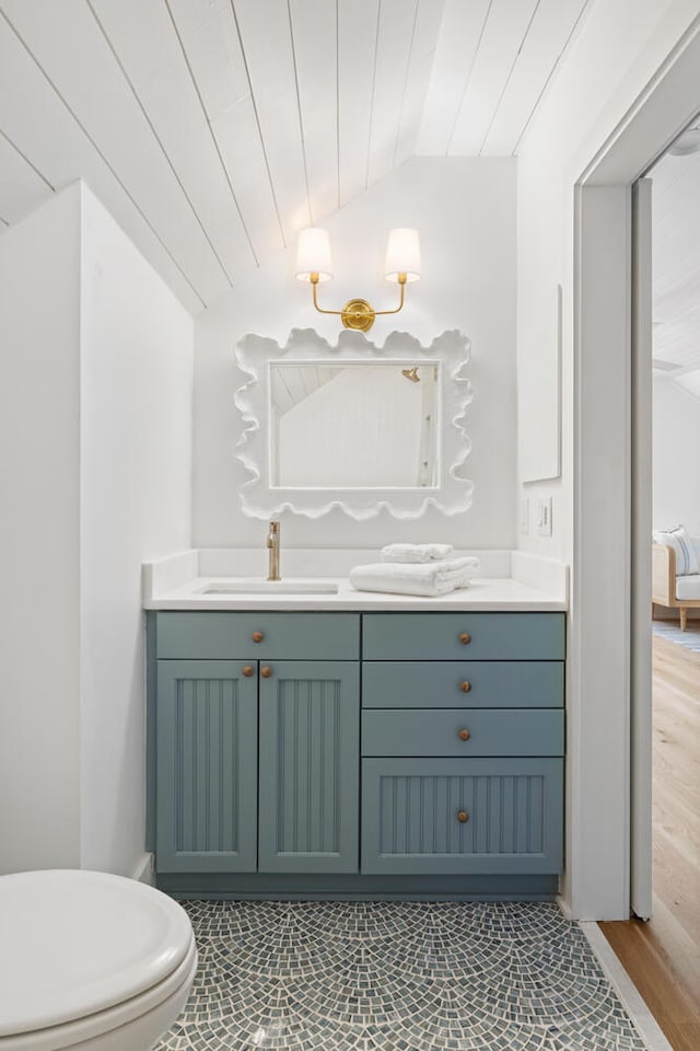 bathroom with lofted ceiling, vanity, wooden ceiling, and toilet