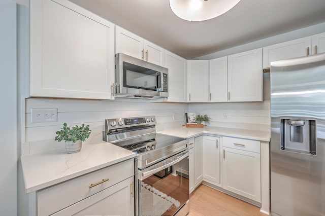 32 Briarcliff Dr, Charleston, SC 29407 - kitchen with appliances with stainless steel finishes, white cabinets, and light wood finished floors
