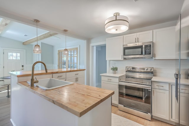 32 Briarcliff Dr, Charleston, SC 29407 - kitchen with stainless steel appliances, a sink, butcher block countertops, a kitchen island with sink, and light wood-type flooring
