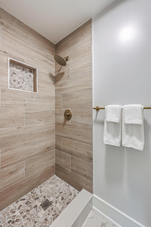 32 Briarcliff Dr, Charleston, SC 29407 - bathroom featuring a tile shower, marble look tiles, and baseboards