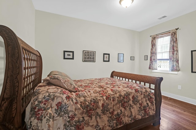 bedroom featuring dark hardwood / wood-style flooring