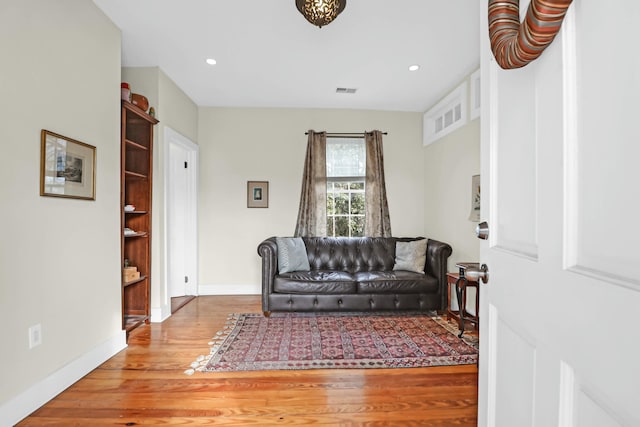 living room featuring hardwood / wood-style flooring and built in features