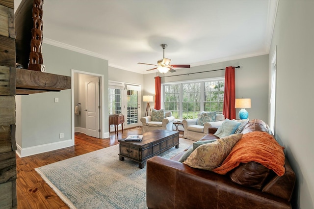 living room featuring hardwood / wood-style flooring, crown molding, ceiling fan, and a healthy amount of sunlight