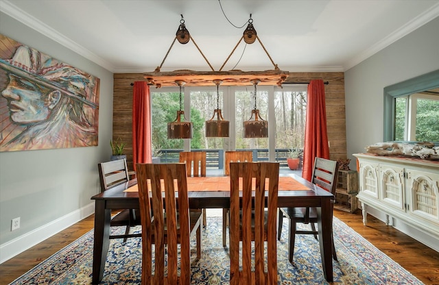 dining space with dark hardwood / wood-style floors, ornamental molding, and a chandelier